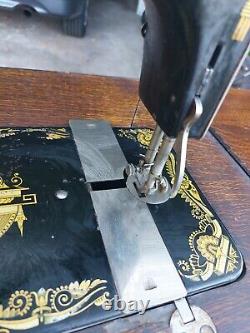 1904 Antique Singer treadle sewing machine in cabinet