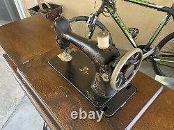 Antique 1910 Singer Sewing Machine with Oak Treadle Cabinet includes accessories