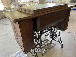 Antique 1910 Singer Sewing Machine with Oak Treadle Cabinet includes accessories