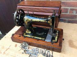Antique 28K Old Singer sewing machine with coffin storage Case and attachments
