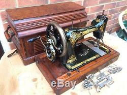 Antique 28K Old Singer sewing machine with coffin storage Case and attachments