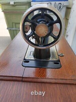 Antique Singer Sewing Machine Lotus Decals in a seven drawers cabinet, working