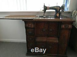 Antique Singer Sewing Machine in Oak Cabinet with sewing machine