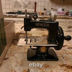 Antique Singer children's sewing machine with original box and instructions