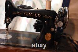 Antique Singer sewing machine with wood case and has key