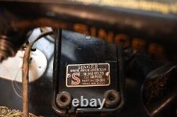 Antique Singer sewing machine with wood case and has key