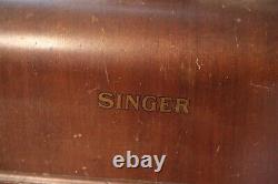 Antique Singer sewing machine with wood case and has key