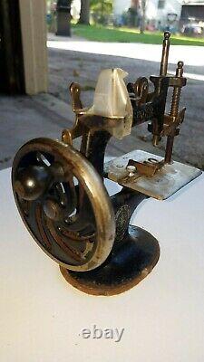 Antique childs hand crank singer sewing machine