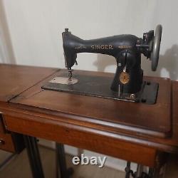 Antique singer sewing machine in cabinet