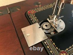 Antique singer sewing machine red eye