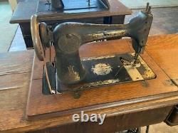 Antique singer treadle sewing machine in cabinet