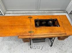 Antique singer treadle sewing machine in cabinet