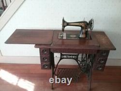 Antique singer treadle sewing machine in workable condition Has new belt