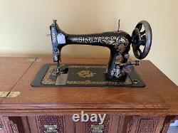 Antique totally refurbished No. 27 Singer sewing machine in cabinet, with parts