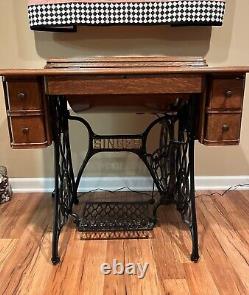 Vintage singer treadle sewing machine in cabinet