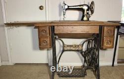 Vintage singer treadle sewing machine in cabinet