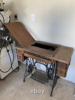 Vintage to Antique Singer treadle sewing machine in table cabinet